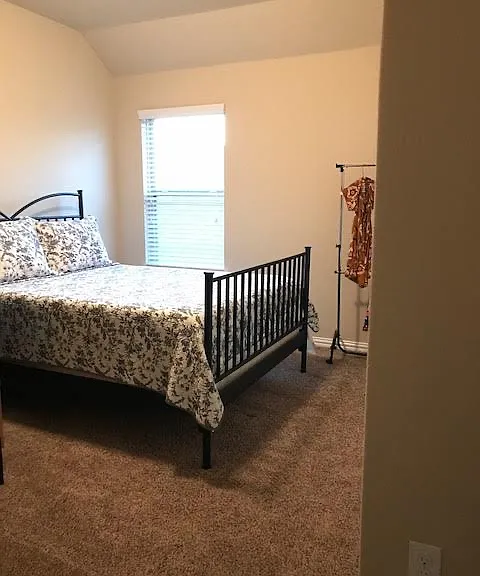 Smaller upstairs bedroom with attic access to the left