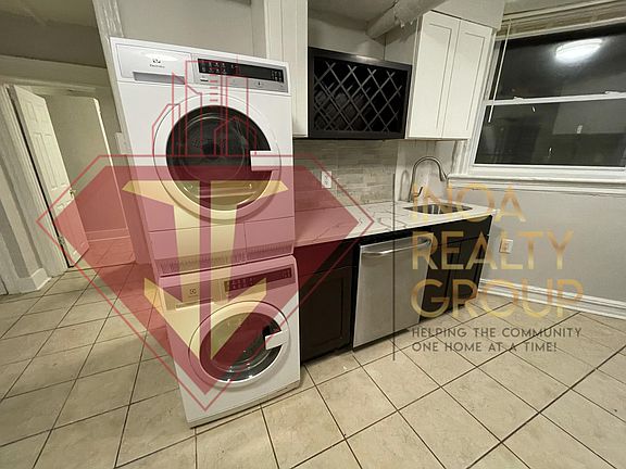 Kitchen with laundry in unit, dishwasher, and modern cabinets.