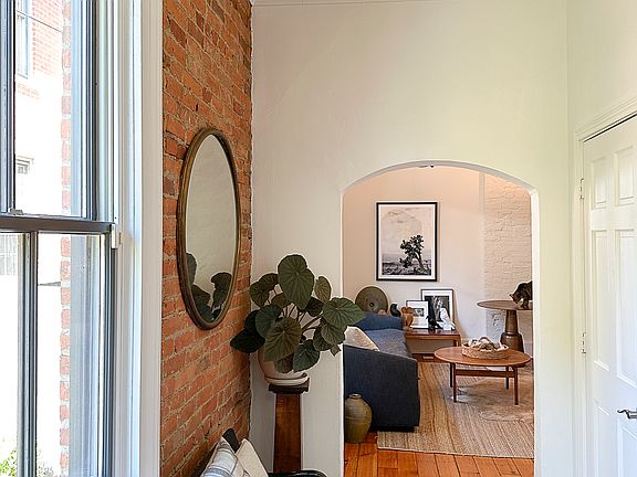 Front entry hall and large coat closet with Elka shelving, looking toward living room