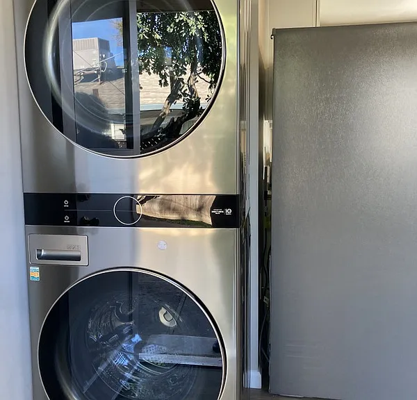 Stacked Washer/Dryer in kitchen area.