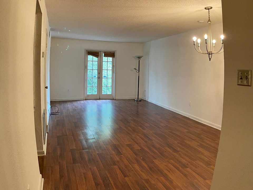 Living room facing back balcony French doors.