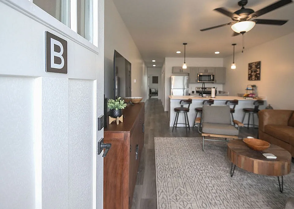 Inviting open-concept apartment with modern kitchen and cozy living area, perfect for relaxation and entertaining.