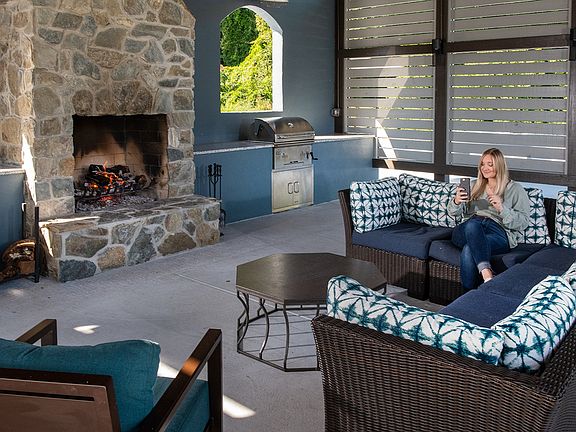 Outdoor Lounge with Grilling Area and Stone Fireplace at The Flatts Salisbury