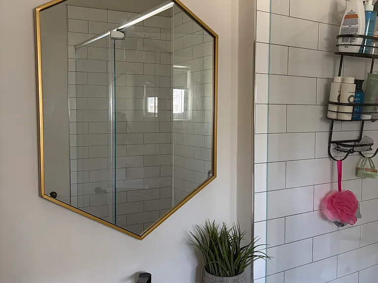 Spacious second bath with glass shower and river stone
