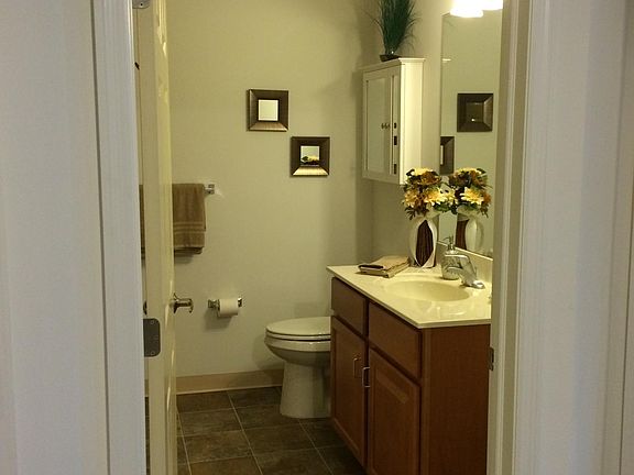 Bathroom includes walk-in shower and washer dryer; access point to extra storage is in the ceiling.