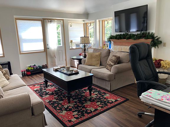 Light & bright living room with vaulted ceilings. Gorgeous new flooring throughout.