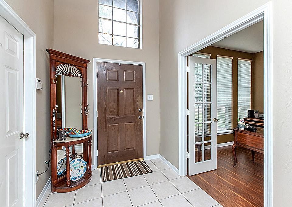 TWO STORY TILED ENTRY FEATURING STUDY WITH FRENCH DOORS ~