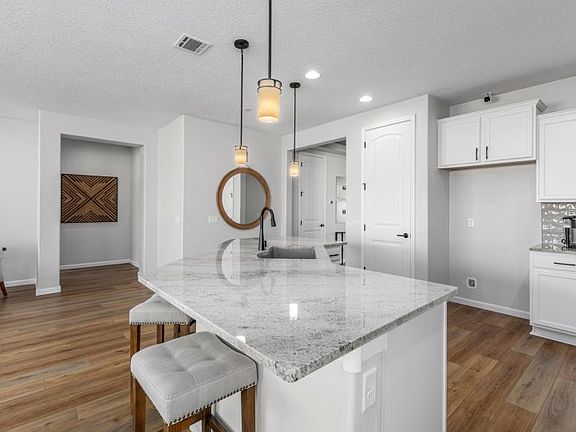 Kitchen with large island and breakfast bar designed for busy mornings.