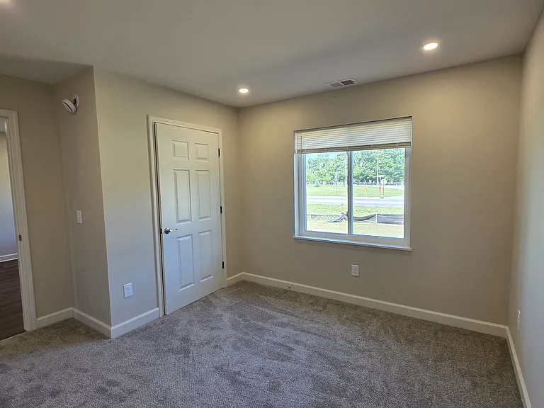 Another view of bedroom with attached bathroom.