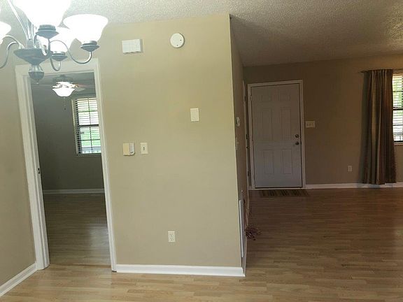 view from kitchen of master bedroom door and living room fro