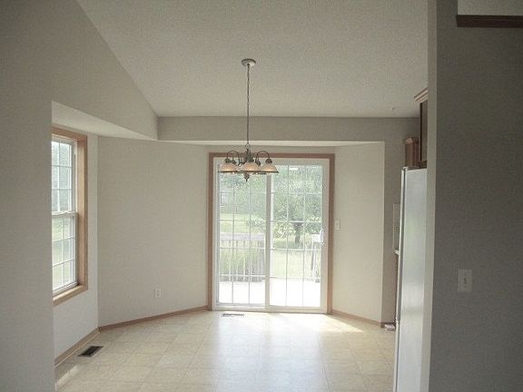 Dining room leading out to deck in backyard.