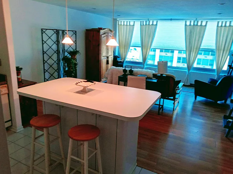 Open kitchen looks out at the lake and marina from entry and island.