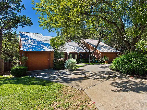 A circular drive provides parking for 8 vehicles,  and three garage stalls.