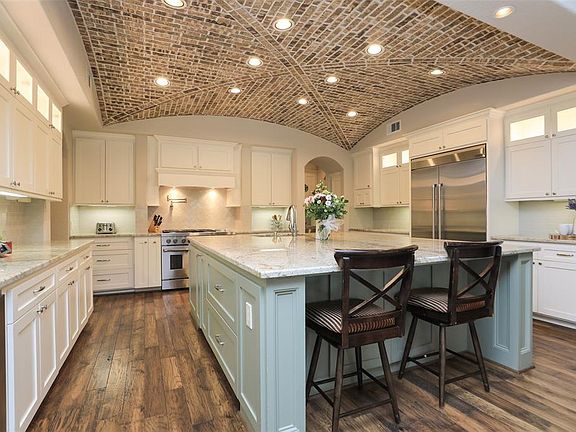 Chefs kitchen w large island and groin brick ceiling