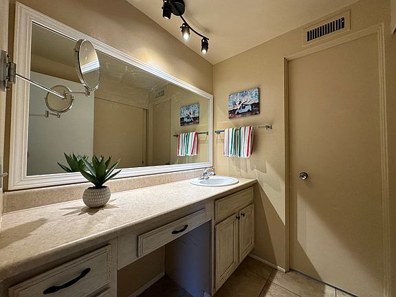 Bathroom sink separate from shower / toilet area