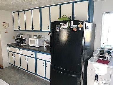 full kitchen with toaster oven and table and two chairs not shown in picture