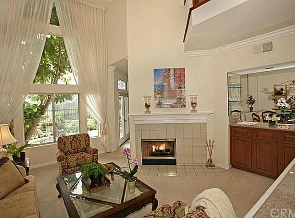 Living Room with Fireplace, High Ceiling and Window for Views, Wet Bar accessed from Living Room or Kitchen/Family Room Area