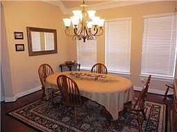 Elegant Formal Dining with Hardwood Floors, Neutral Colors &amp; a Nice Chandelier
