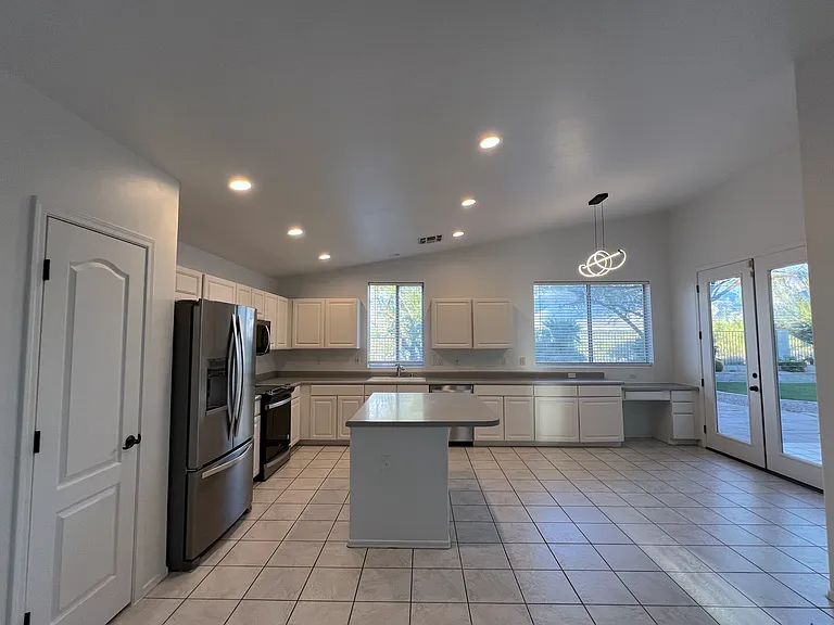 Kitchen, with brand new appliances, and French door to backyard.