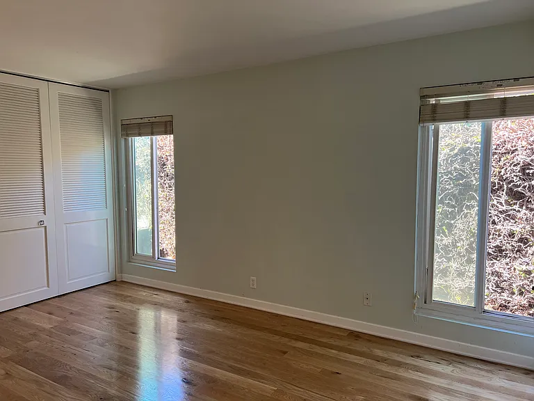 Bedroom #2 with a closet lining an entire wall.