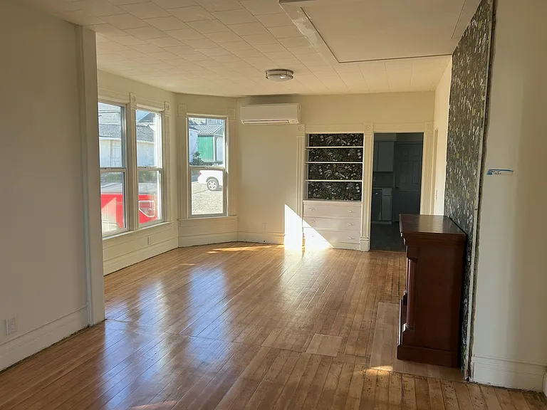 Open floor plan LR/DR with electric fireplace, built-in shelf/drawers and new A/C mini-split heating system