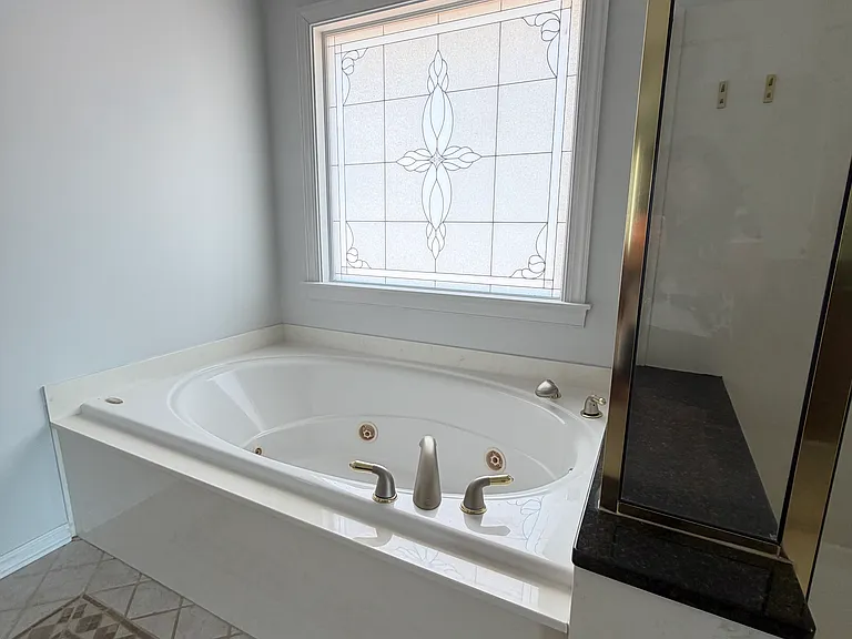 Deep soaking tub with a bright, frosted window_privacy and natural light for relaxing, unhurried baths after days on the water.