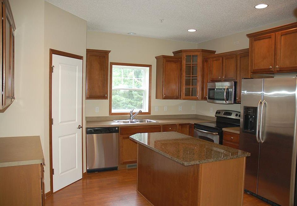 Gorgeous kitchen with granite countertops, stainless steel appliances, pantry, and window over the sink.