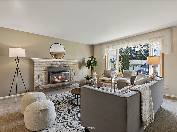 Upstairs living room with electric fireplace & lots of natural light. 