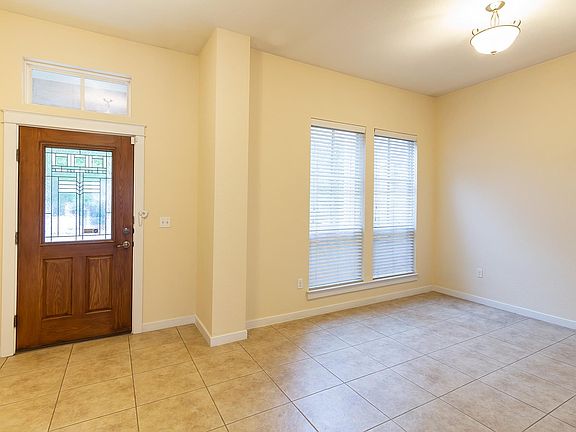 front entry & front living area, half bath to the left