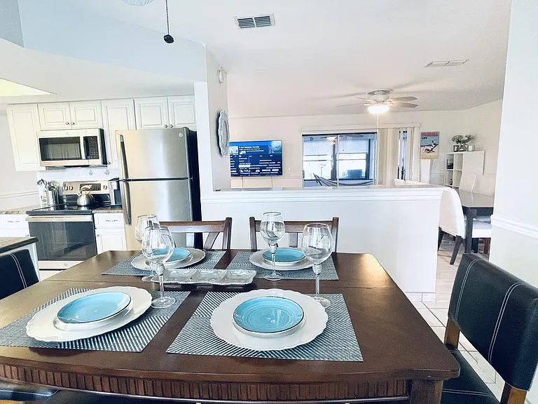 Interconnecting spaces with modern kitchen that offers counter height dining table (sits 8 with extension leaf inside with the extra chairs available in the garage).