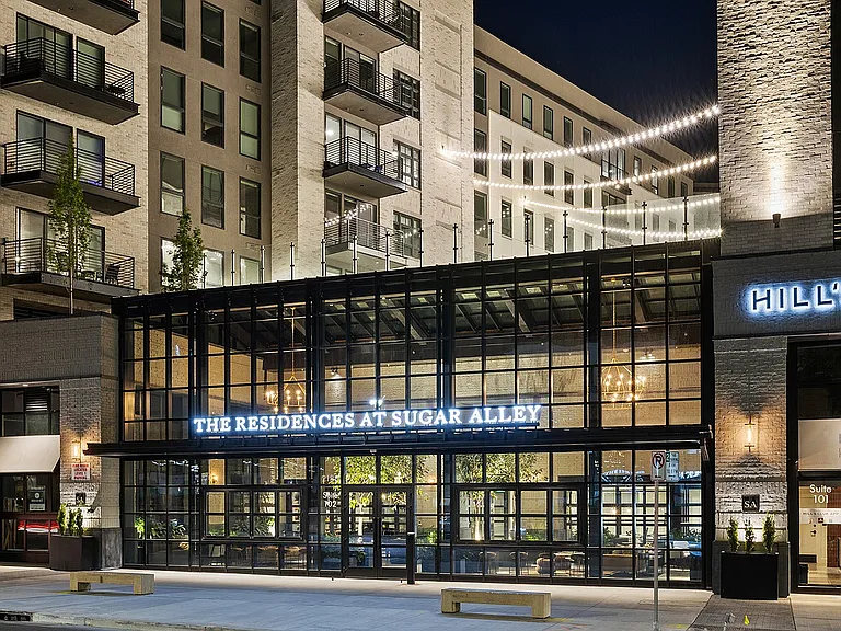 Evening exterior of Sugar Alley with modern architecture