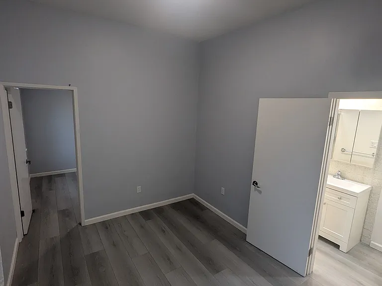 Office area looking into bedroom and bathroom.