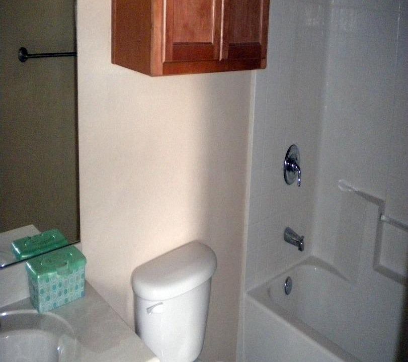 Full bath with tub shower and ceramic tile
