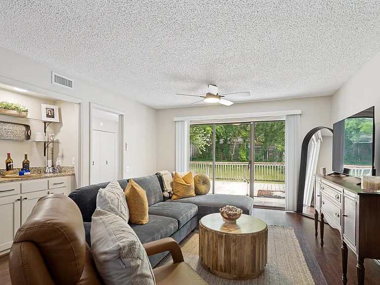 coffee bar on the left with kitchen entry beside it, sliding door to back covered patio and wood deck
