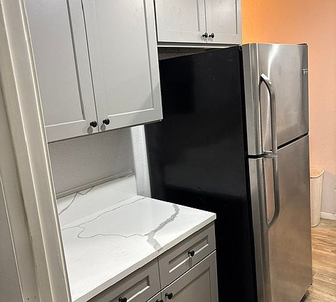 Kitchen with new cabinets, appliances, and new tiled floors