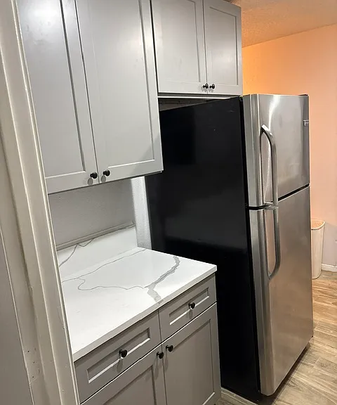 Kitchen with new cabinets, appliances, and new tiled floors