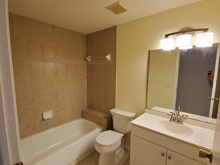 Updated Hall bathroom with new vanity, toilet, faucet and light fixture.