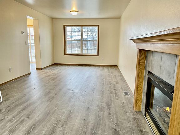 Living room and dinning room area with gas fireplace, luxury vinyl plank floors!