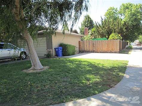 Side of home with a second driveway which could become RV parking.