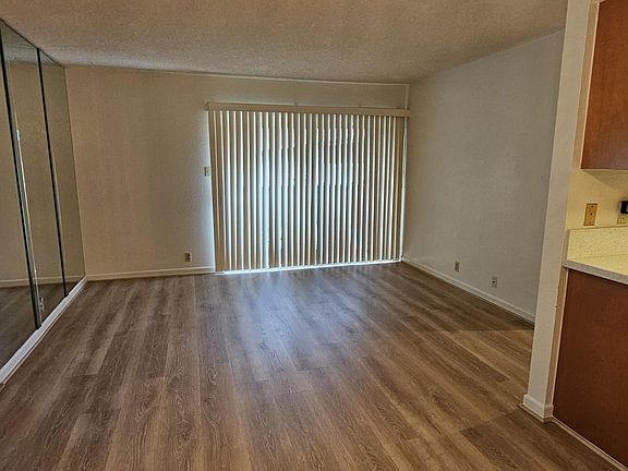 Large living area with balcony. Mirrored wall provides an even more spacious feeling.