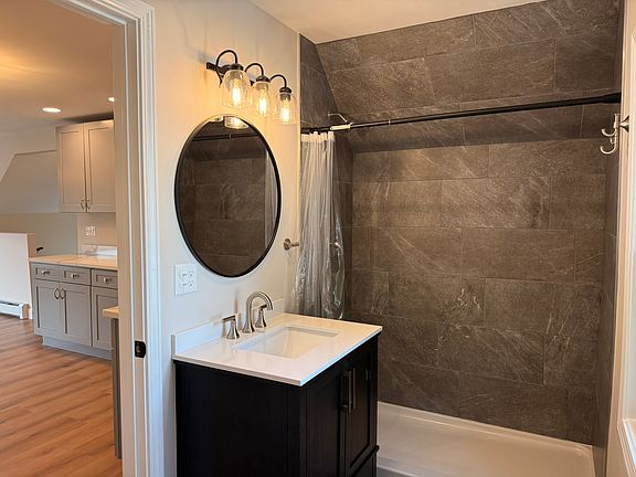 BATHROOM - huge tiled shower, all brand new fixtures and finishes, new beautiful solid wood vanity with quartz top.