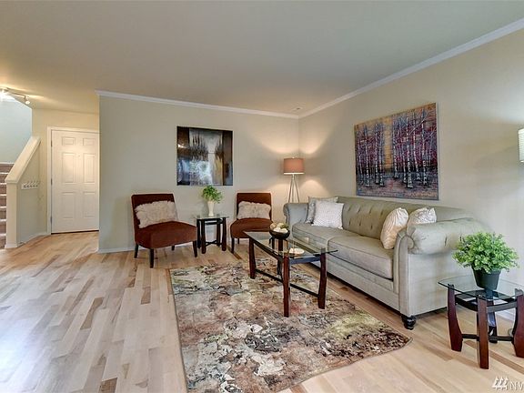 Comfy living room with crown molding, fresh paint and beautiful hardwood floors.