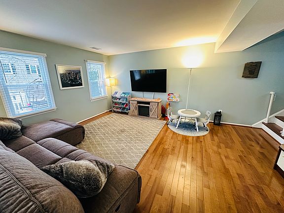 Living room with gleaming hardwood floors and plenty of natural light