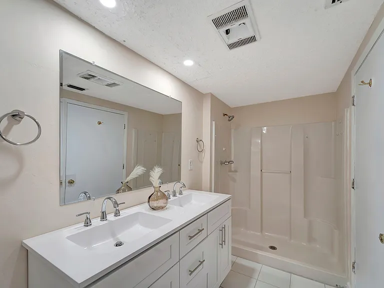 Bathroom A has a large double vanity and plate glass mirror. Shower Only (not pictured - shower curtain and rod)