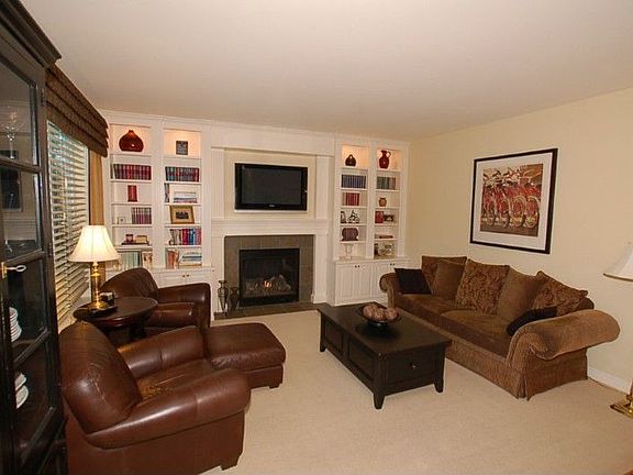 Family room with gas fireplace and custom built-in shelves and lighting.