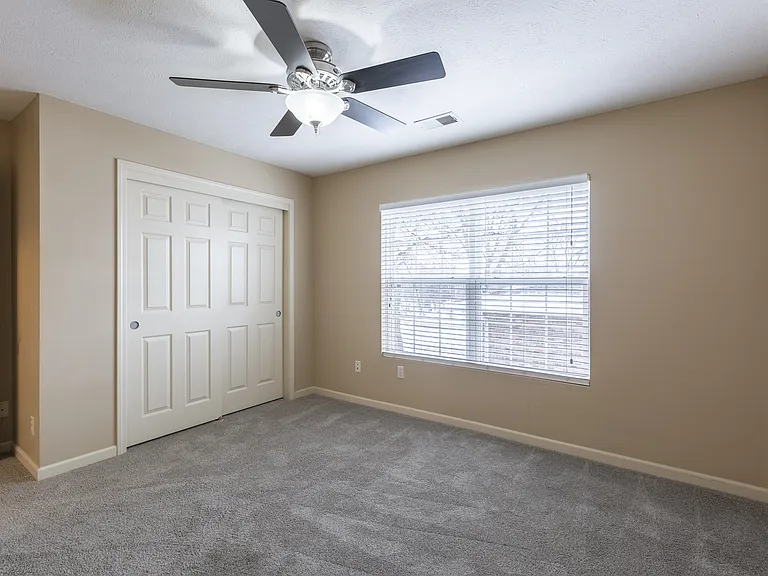 Bedroom with a large closet at Square 131 12-Plex.