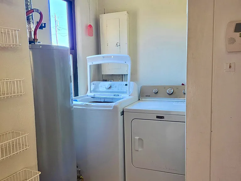 Laundry room with new washer and dryer