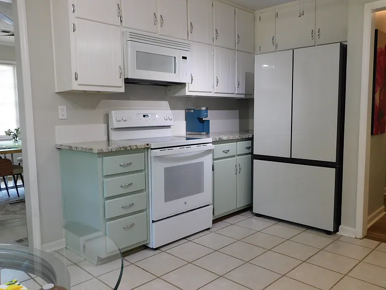 New Keurig coffee maker.
Freshly painted kitchen, granite countertop, bespoke glass door refrigerator, ceramic range, microwave.