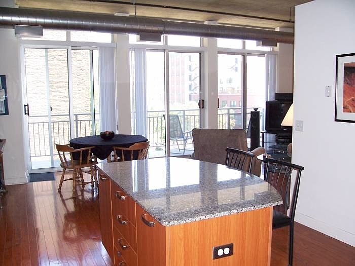 Kitchen and Dining Area with Balcony that extends across uni