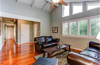 Living room with vaulted, high-beam ceilings